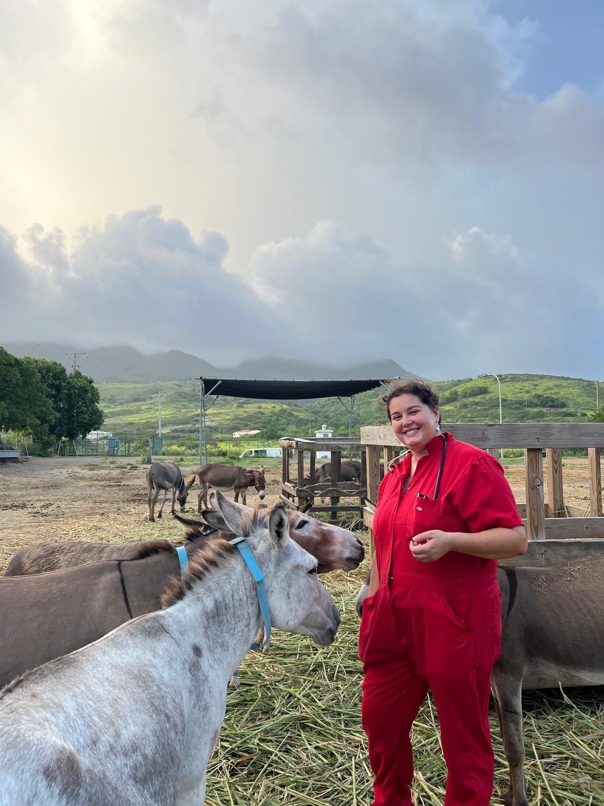 Grace Ritter with two donkeys in the pasture