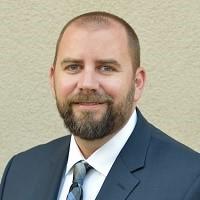 a headshot of Dr. David Kenneally