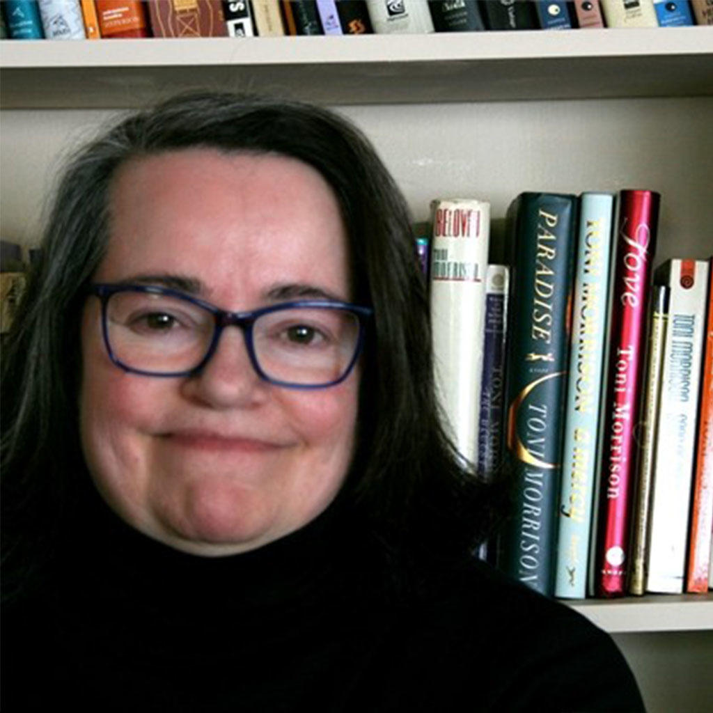 Woman with black rimmed glasses and dark hair