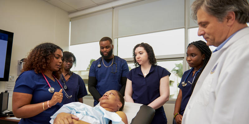 Medical professionals with patient in learning environment